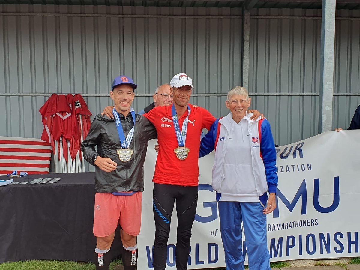 Dominik Erne on the podium with two other athletes at the 48-hour World Championships