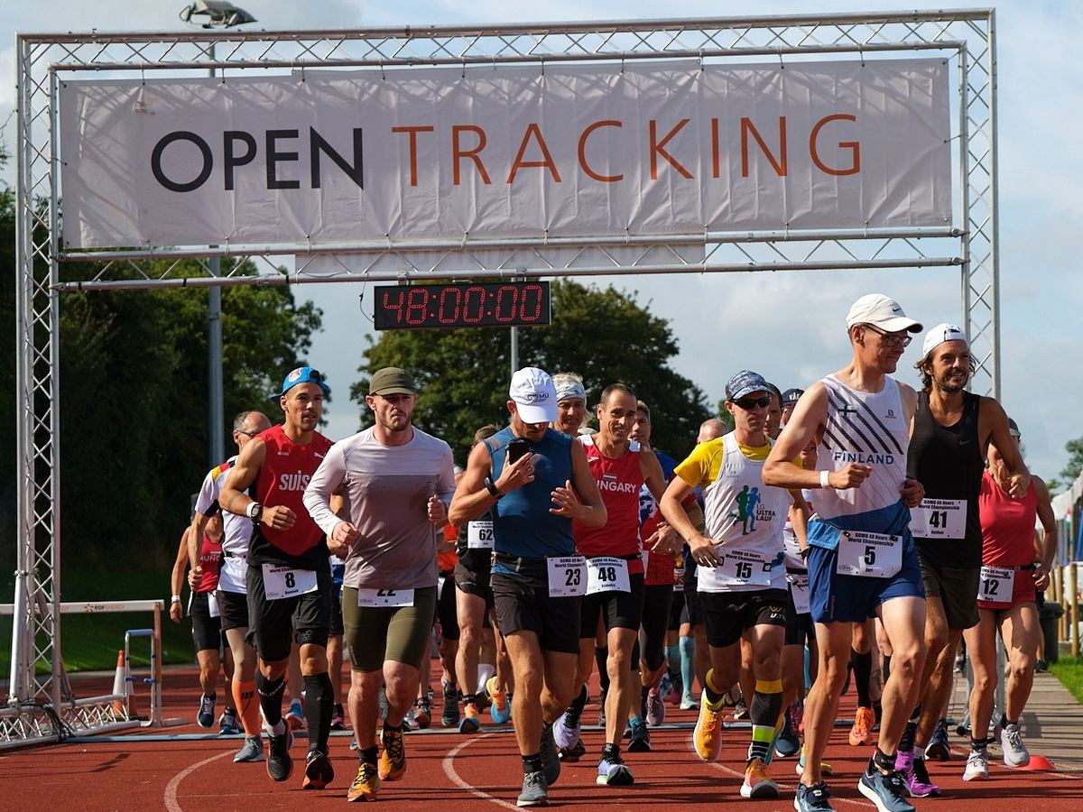Runners under the start gantry with the clock at 48:00:00