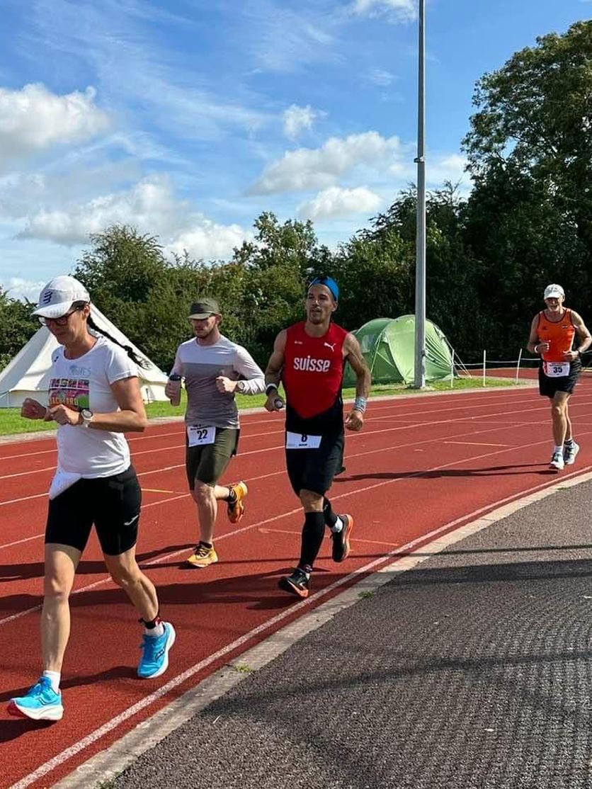 A group of runners on the athletics track