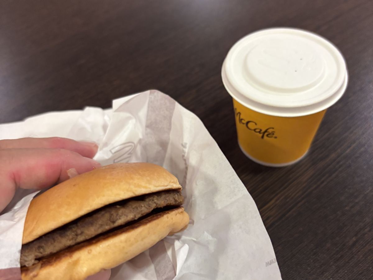 A hamburger and an espresso on a table