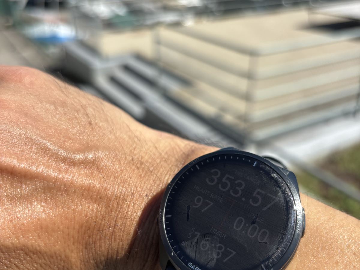 A running watch with boats in a harbour behind