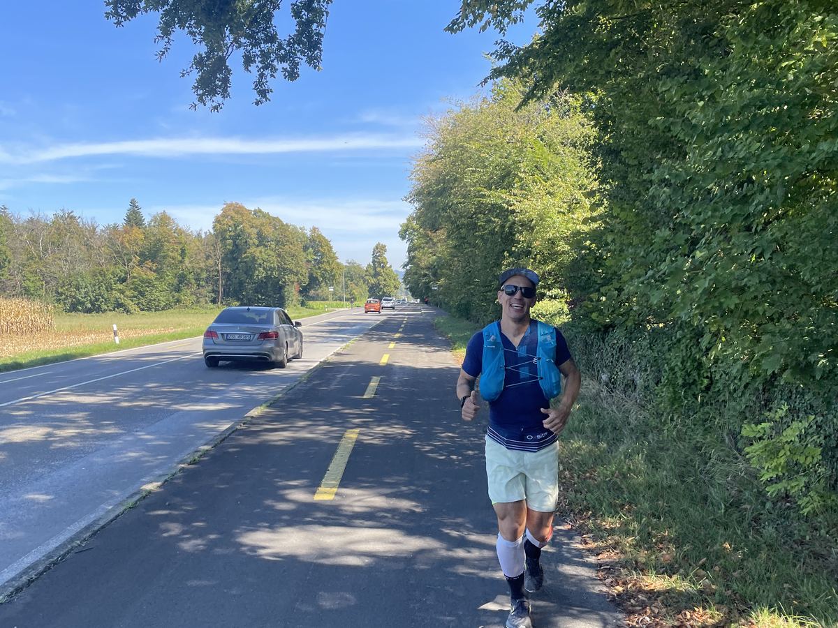 A runner on a lakeside road