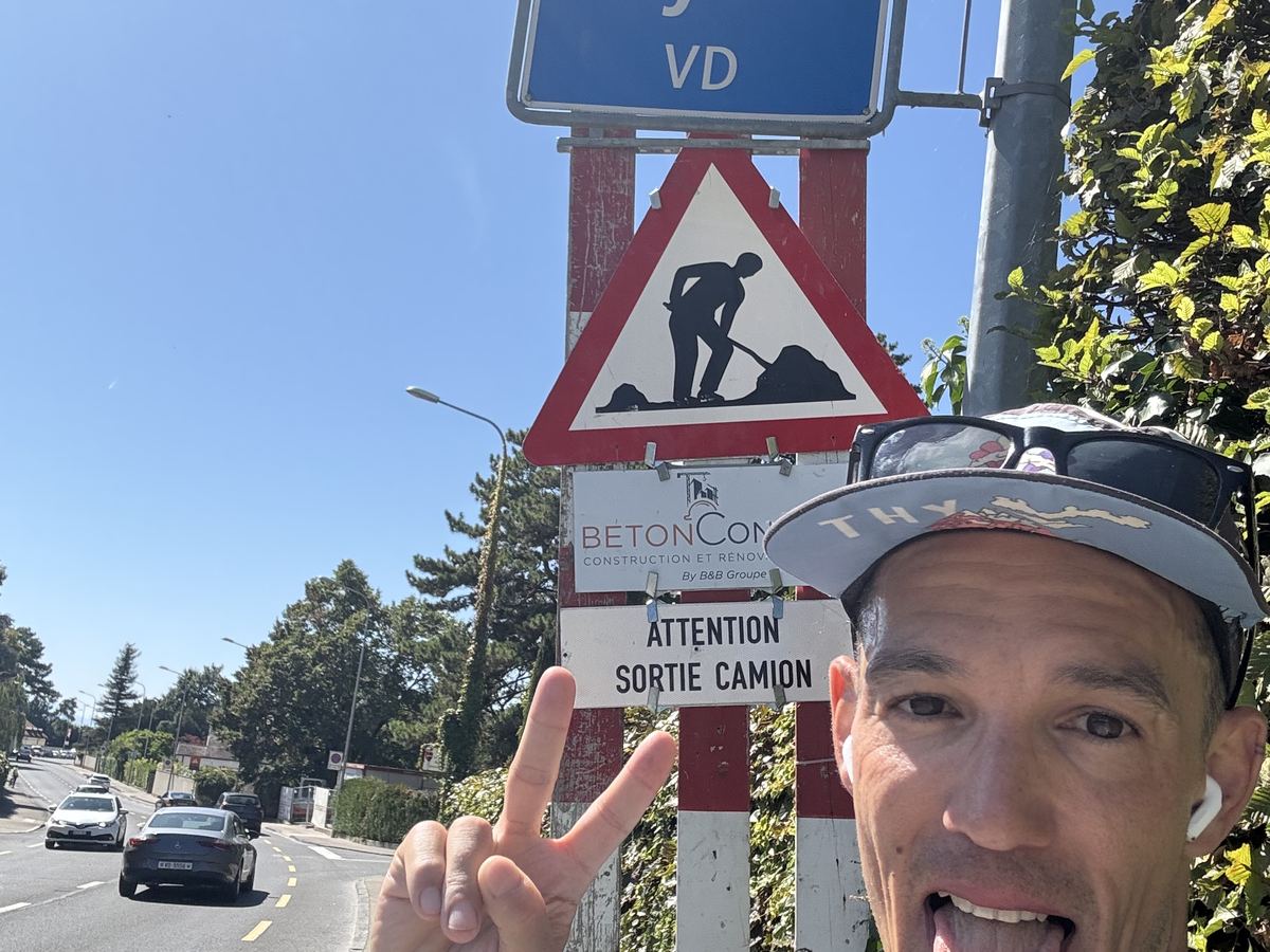 Dominik Erne in front of the Nyon road sign