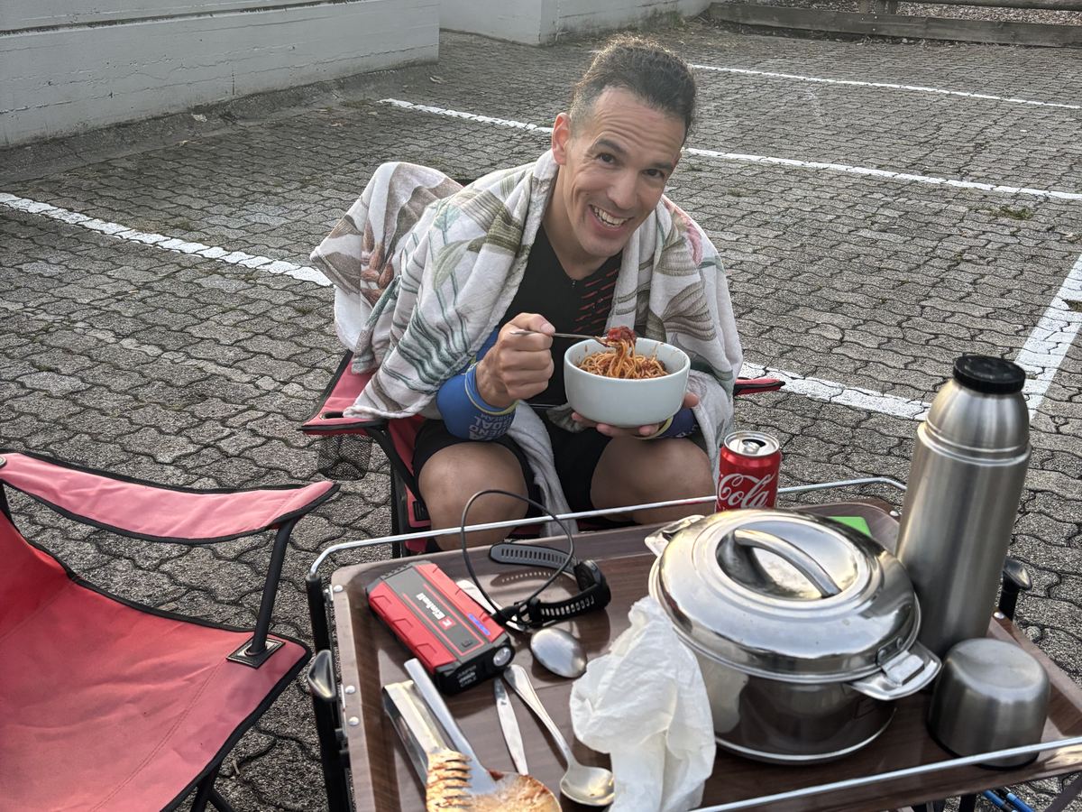 Dominik Erne eating pasta at a camping table