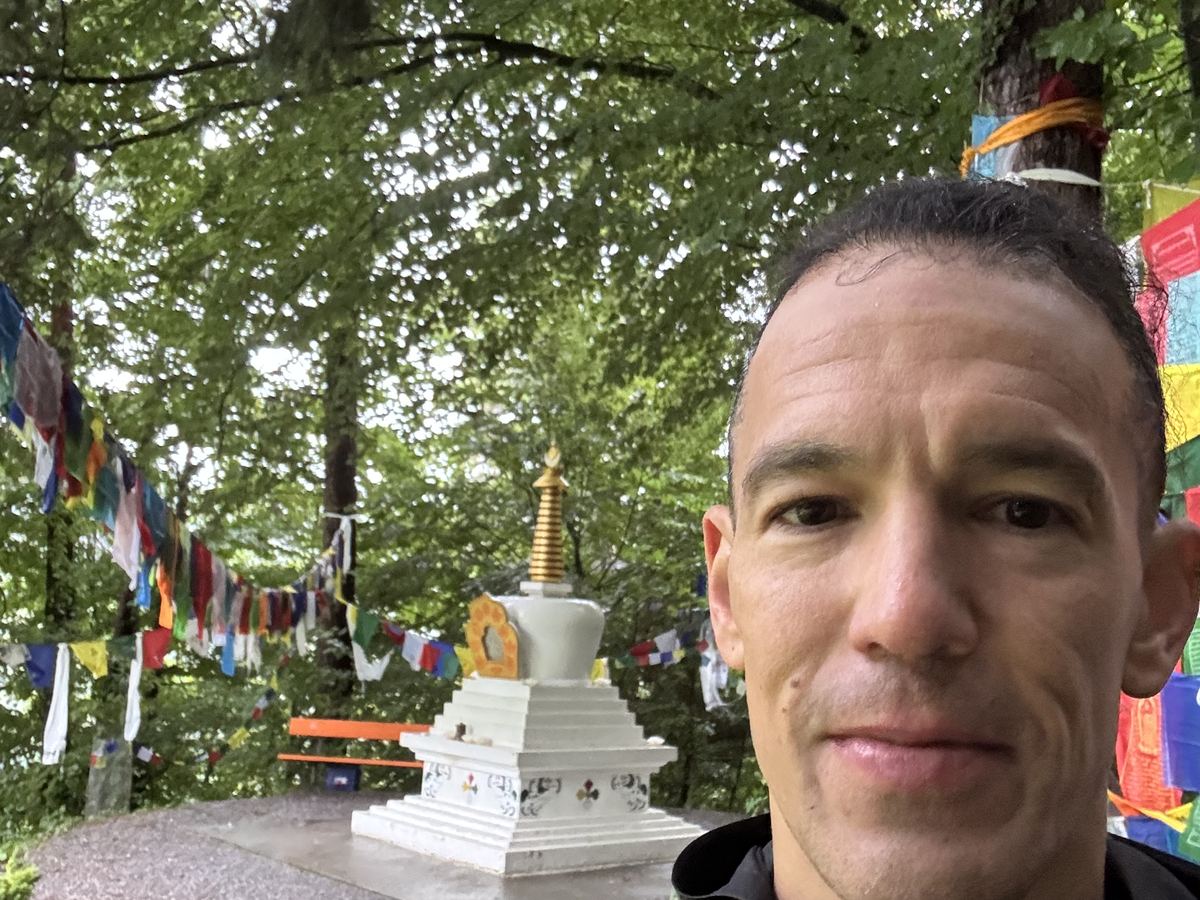 Dominik Erne beside prayer flags at the Tibet Institute Rikon